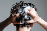 Rear view of men washing hair with shampoo and foam on white backdrop