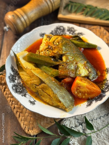 fish head curry or known as kari kepala ikan bawal is a famous Malaysian dish to eat with white rice photo