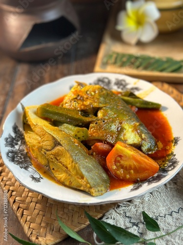 fish head curry or known as kari kepala ikan bawal is a famous Malaysian dish to eat with white rice photo