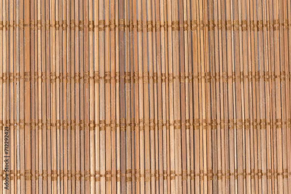 Texture of place mat woven from thin natural bamboo sticks Texture of place mat woven from thin natural bamboo sticks