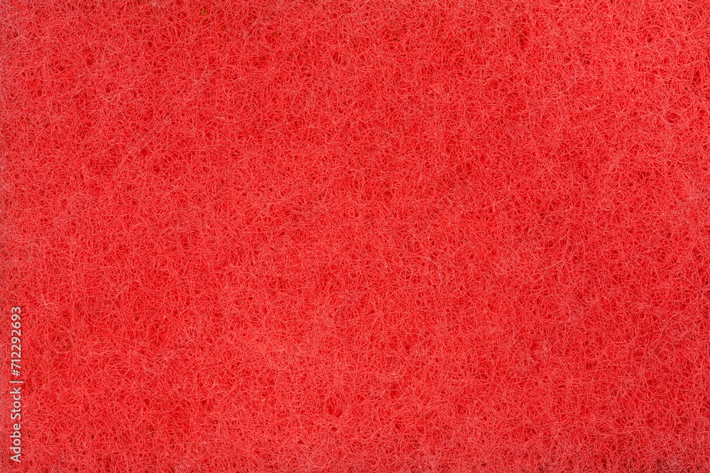 Fototapeta premium Texture of red hard synthetic material of kitchen cleaning sponge