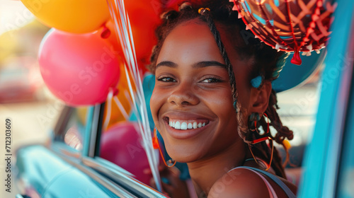 A young woman with balloons is in a car.