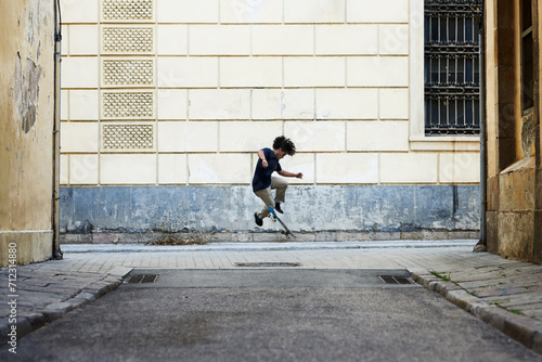 Boy performing skateboarding tricks in the street.