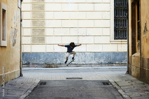 Skater performing trick in the street.