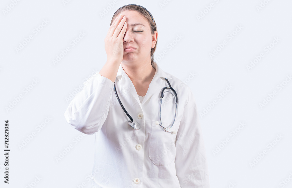 Stressed female doctor with hand on forehead isolated. Exhausted young female doctor with hand on forehead Stressed female doctor with hand on forehead isolated. Exhausted young female doctor with hand on forehead