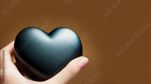 hands holding heart, disappointed love, black heart on brown leather background, valentine's day