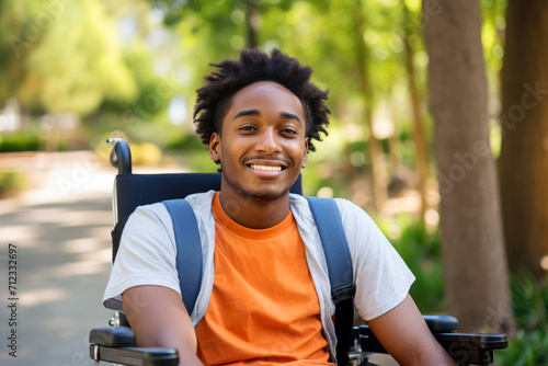 Joyful African American man in wheelchair, summer park - injury recovery concept