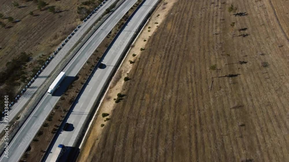 cars driving along the highway, top view, view from a drone. forward movement. autumn landscape. travel between cities cars driving along the highway, top view, view from a drone. forward movement. autumn landscape. travel between cities