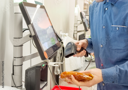 Bild auf Leinwand Customer pays his purchase at the supermarket,self checkout systems in  retail s