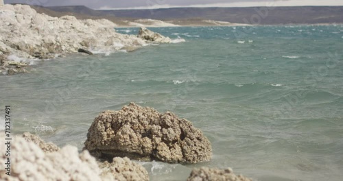 waves crashing on the rocks in a windy bay