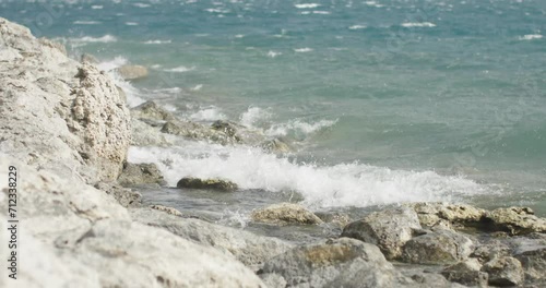 waves crashing on the shore of a lake on a windy day