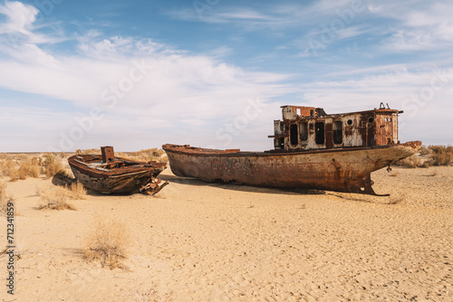 rusty ship at the bottom of the former Aral Sea. The dried-up sea in an environmental disaster and climate change in Central Asia. problems of global warming concept,