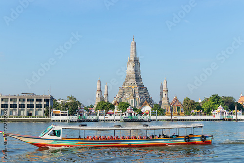 Beautiful temple of dawn Wat Arun Ratchawararam buddhist temple famous with boat and blue sky sunny day travelin Bangkok, Thailand. © Chalearmrat