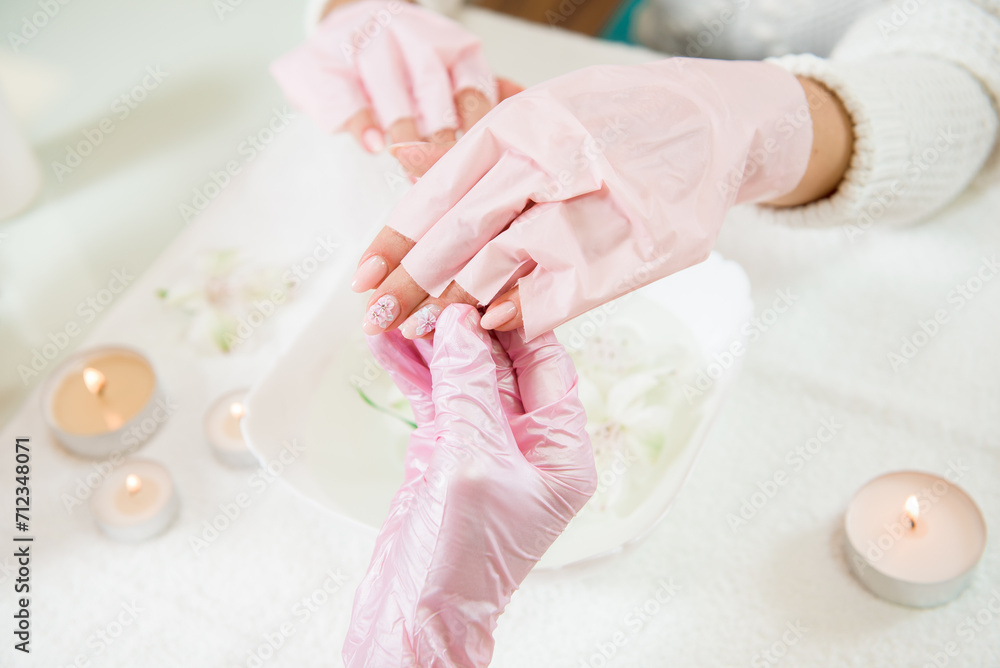 Manicure master holding female hands in a beauty salon. Manicure master holding female hands in a beauty salon.