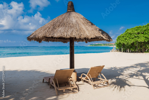 Fototapeta Naklejka Na Ścianę i Meble -  Chairs and umbrella at beach with blue ocean. Holiday tropical banner