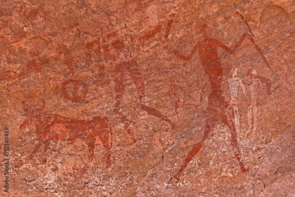 Rock art, petroglyph from the Neolithic period, depictions of human figures, Bouhadian rocks in Tadrart Rouge, Tassili N'Ajjer National Park. Sahara, Algeria, Africa. Rock art, petroglyph from the Neolithic period, depictions of human figures, Bouhadian rocks in Tadrart Rouge, Tassili N'Ajjer National Park. Sahara, Algeria, Africa.