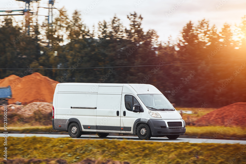 delivery van. A mockup of a white commercial vehicle isolated on the road. Perfect for your business and shipping needs.