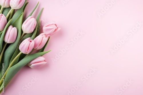 Beautiful composition spring flowers. Bouquet of pink tulips flowers on pastel pink background. Valentine's Day, Easter, Birthday, Happy Women's Day, Mother's Day. Flat lay, top view, copy space © TIYASHA