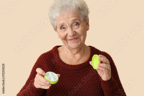 Senior woman with pill box ...