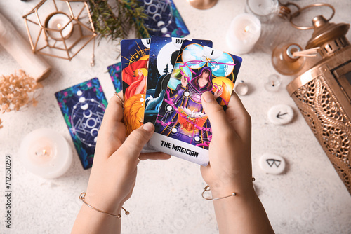 Witch with tarot cards on g...