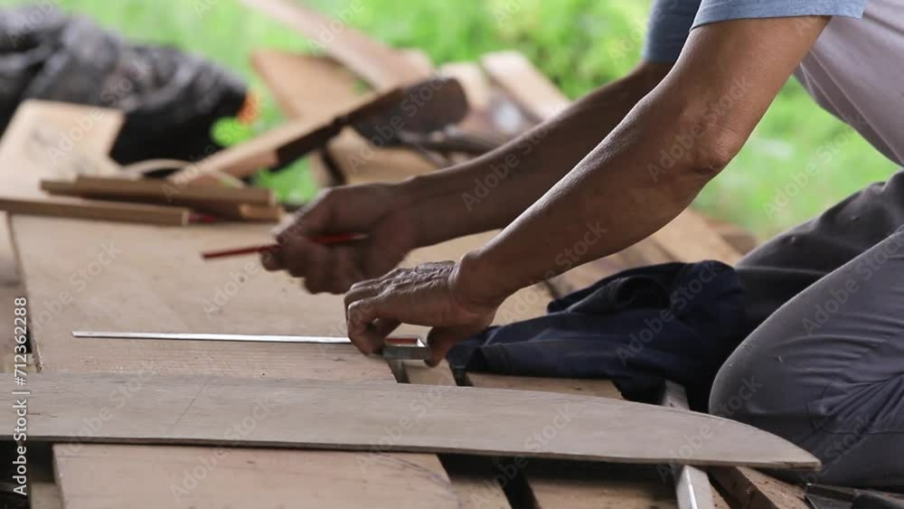 Carpenters are using pencils and rulers to draw lines or marks on the wood for accuracy. Carpenters are using pencils and rulers to draw lines or marks on the wood for accuracy.