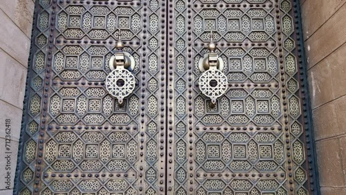 Close-up of a golden textured and decorated door with Moroccan patterns at the Hassan mosque. Rabat, Morocco