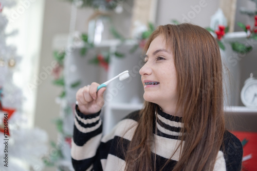 Mixed Race Teenager with Braces Brushing Teeth.