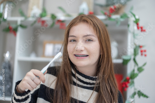 Photos Mixed Race Teenager with Braces Brushing Teeth.