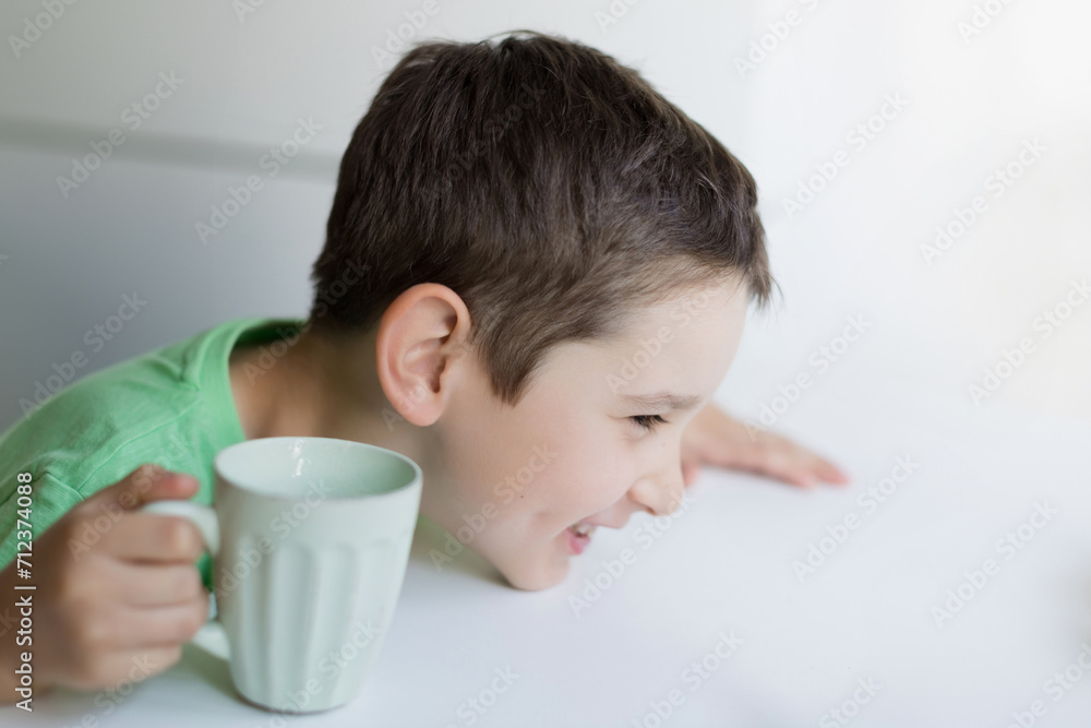 Happy smiling caucasian boy drink milk Happy smiling caucasian boy drink milk