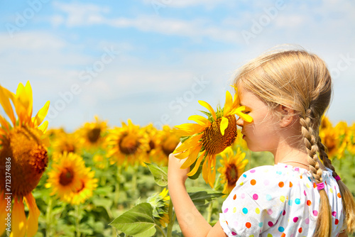 Child playing in sunflower field
