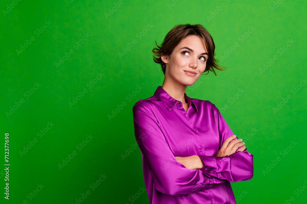 Portrait of smart gorgeous girl folded arms look empty space contemplate isolated on green color background Portrait of smart gorgeous girl folded arms look empty space contemplate isolated on green color background