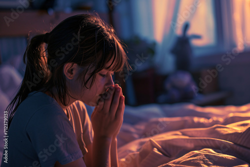 A woman praying at her bedside, prayer, faith, belief in god concept photo