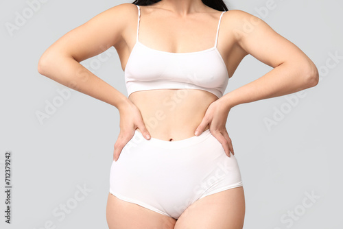 Body positive woman in underwear on light background, closeup