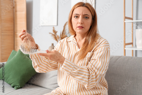 Worried mature woman in paj...