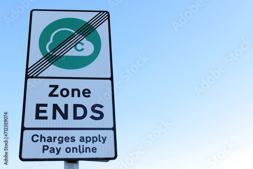 A close up of a reflective Clean Air Zone roadside sign, showing the end of the payment zone. Copy space available in the sky to the right. photo