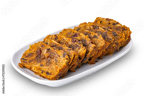 Sliced delicious homemade fruitcake in white ceramic tray isolated on white background with clipping path.