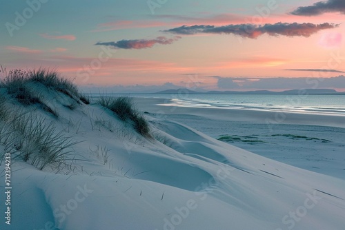 Sand dunes on the beach at sunset