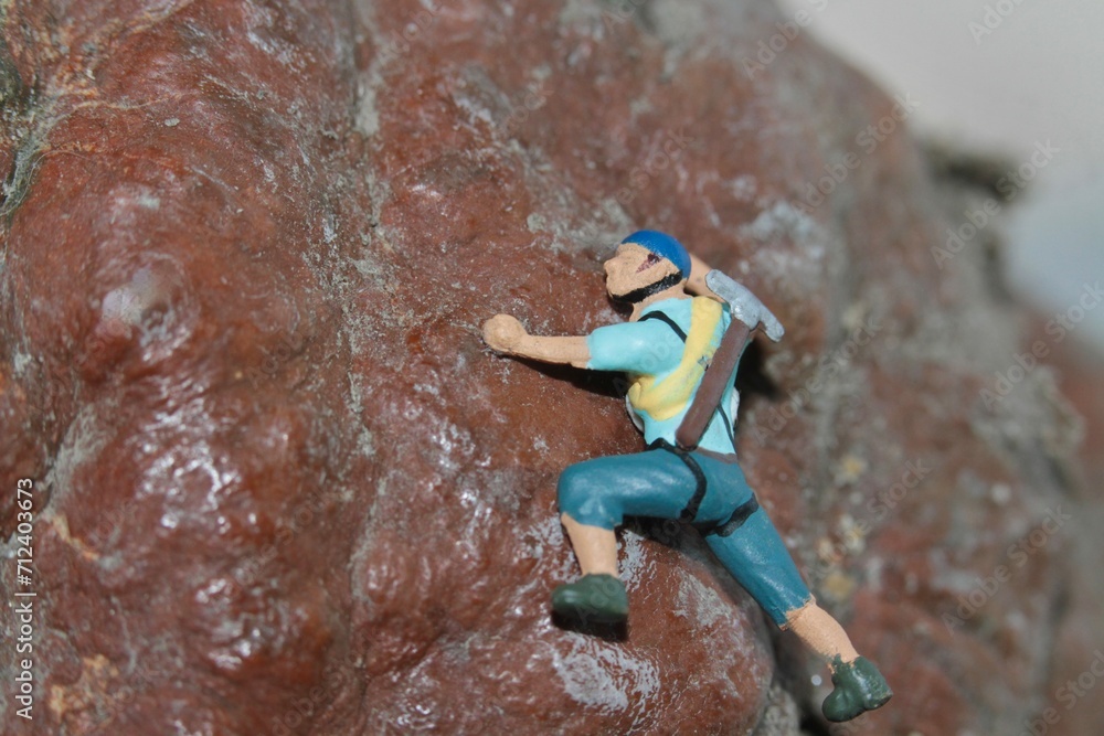 miniature figurine of a climber on a mountain miniature figurine of a climber on a mountain