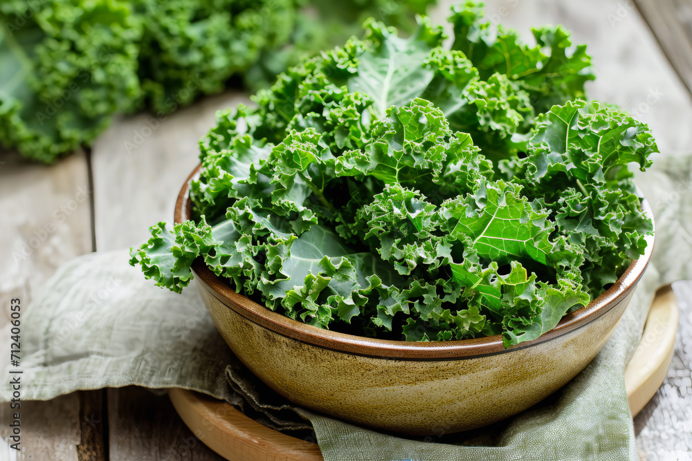 a bowl of kale above wooden table a bowl of kale above wooden table