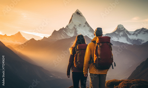 Couple hiker traveling, walking in Himalayas under sunset light.