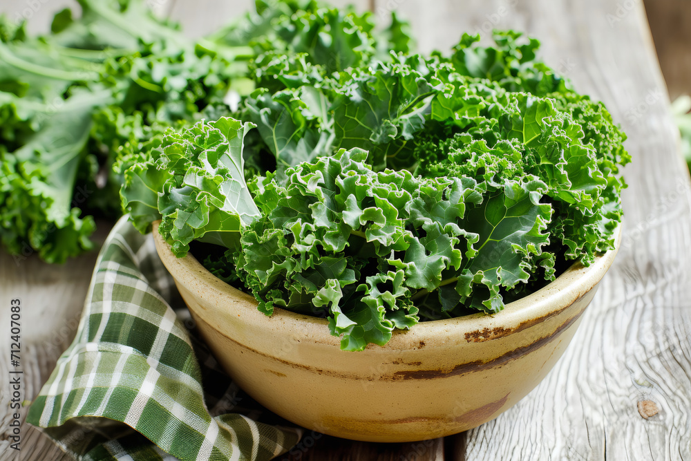 a bowl of kale above wooden table a bowl of kale above wooden table
