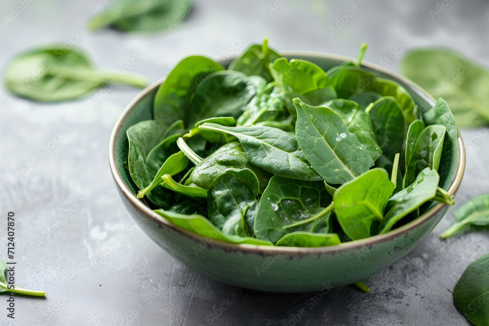 a bowl of spinach above wooden table a bowl of spinach above wooden table