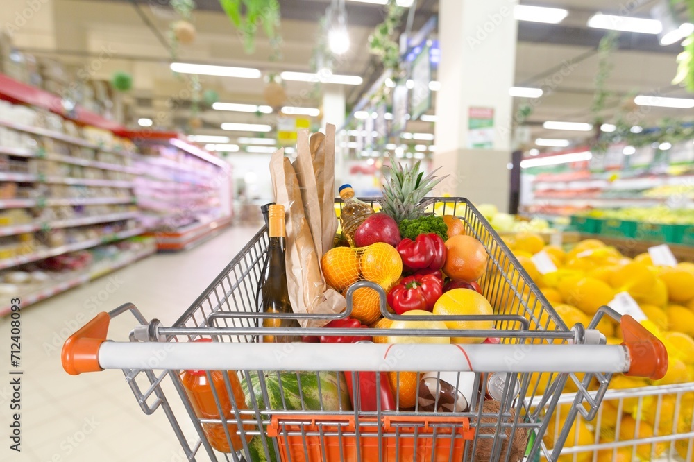 A shopping cart at store with full a supermarket