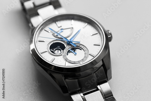 Mechanical moon phase wristwatch with white clock face