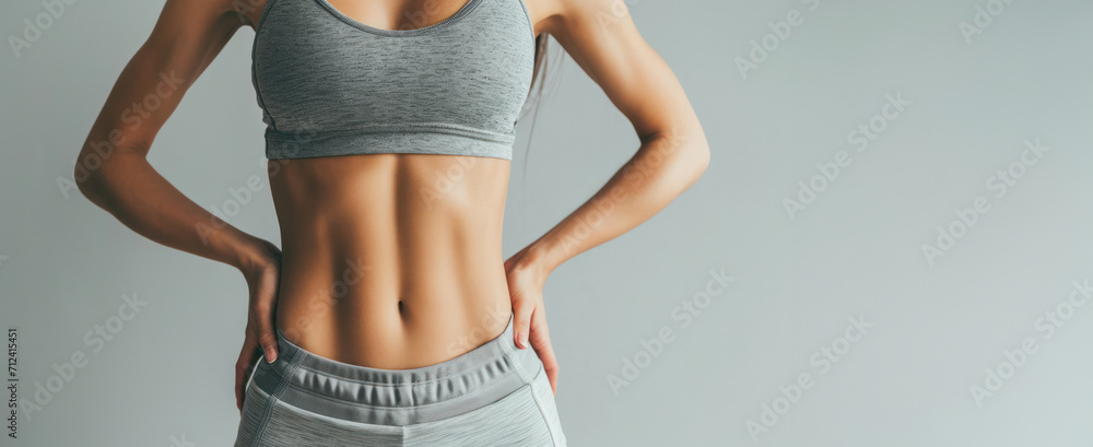 Generative AI, Sporty woman with great abdominal muscles shows stomach in sportswear on neutral background - obrazy, fototapety, plakaty 