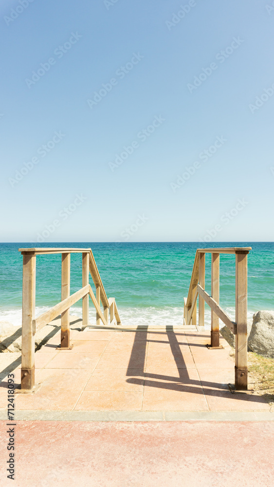 wooden stair leading to an idyllic beach. Mediterranean, Barcelona