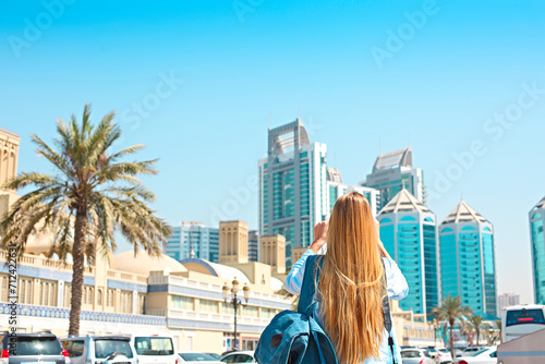 Woman taking mobile photo of the Central Souq in Sharjah City, United Arab Emirates photo