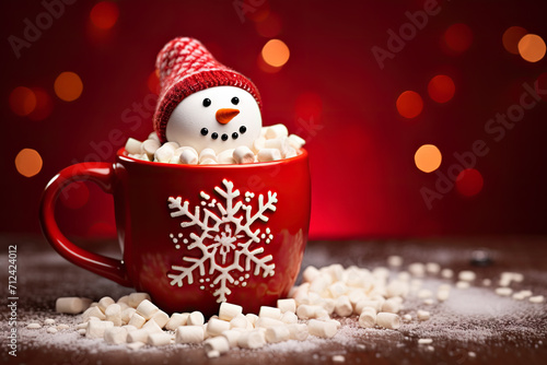 Red mug with hot chocolate with melted marshmallow snowman