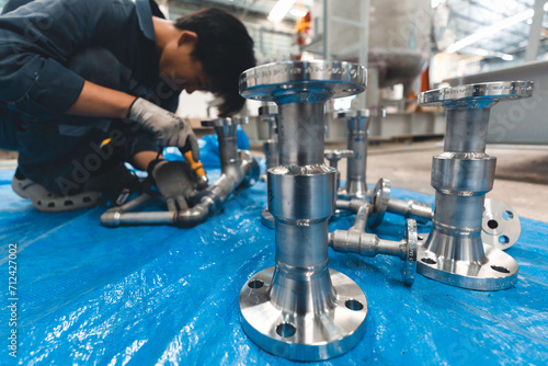 A man starts using a weld hardness the stainless steel piping flange valve component