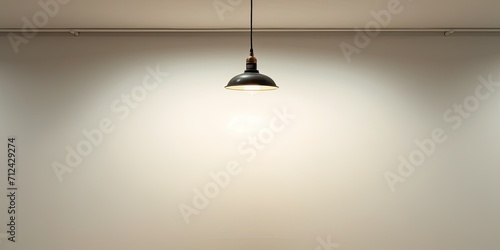 Old lamp suspended from ceiling next to white wall.